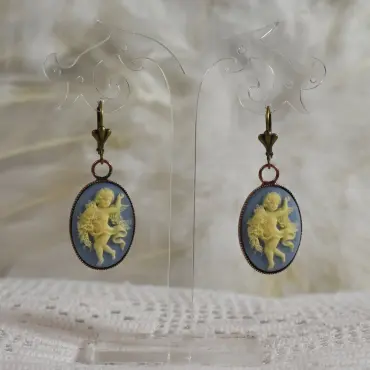 Pendants camée bleu clair au serti bronze, sur dentelle et plumes